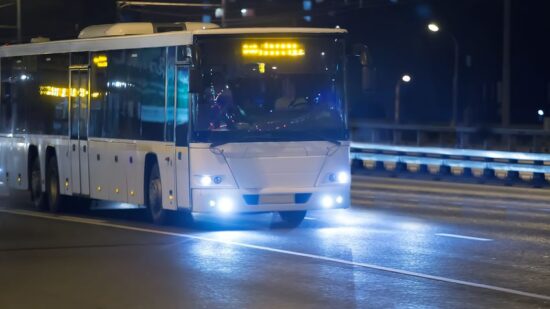 87008454 - bus moves on city street at night